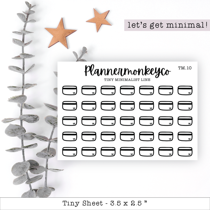 a planner sticker next to a plant
