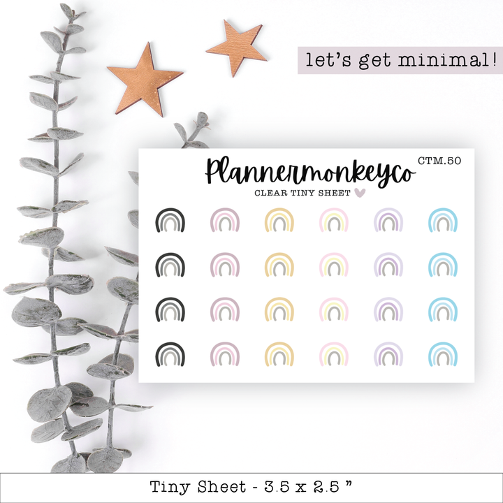a planner sticker with rainbows and stars