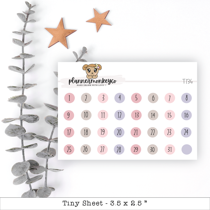 a calendar with a teddy bear on it next to a plant