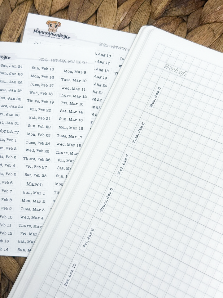 Close-up of a planner with grid paper and printed text on a wooden surface