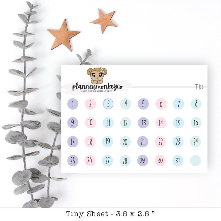 a calendar with a teddy bear on it next to a plant