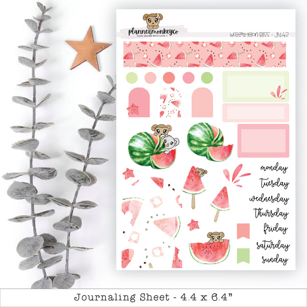 a pink and green planner sticker next to a plant