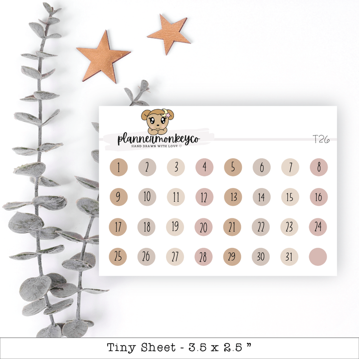 a calendar with a teddy bear on it next to a plant