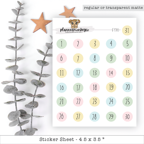 a calendar with a teddy bear on it next to a plant