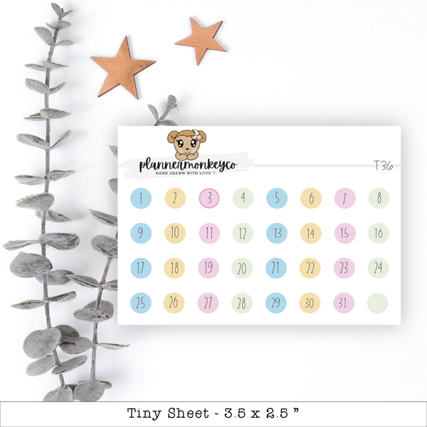 a calendar with a teddy bear on it next to a plant