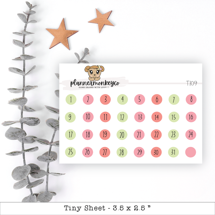 a calendar with a teddy bear on it next to a plant