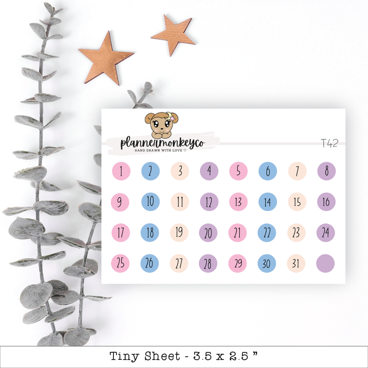 a calendar with a teddy bear on it next to a plant