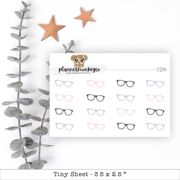 a sticker with a teddy bear and glasses on it